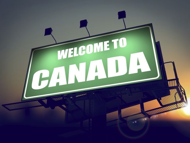 Welcome to Canada - Green Billboard on the Rising Sun Background.
